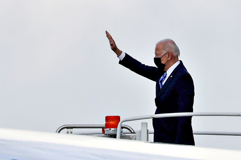 FILE PHOTO: U.S. President Joe Biden waves as he boards