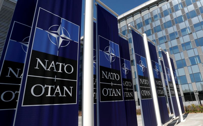 FILE PHOTO: Banners displaying the NATO logo are placed at