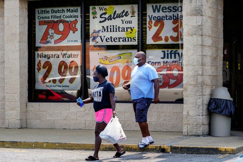 FILE PHOTO: Shoppers leave a Piggly Wiggly supermarket with a