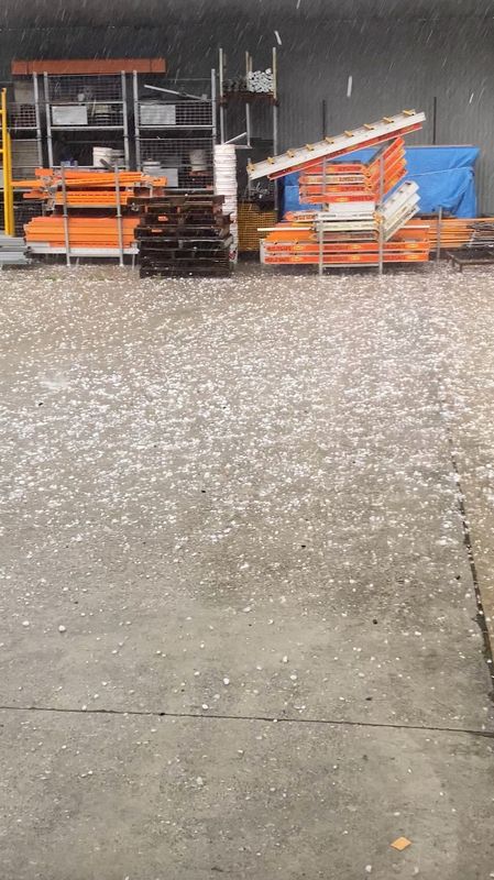 Video still of huge hailstones falling into a garage in