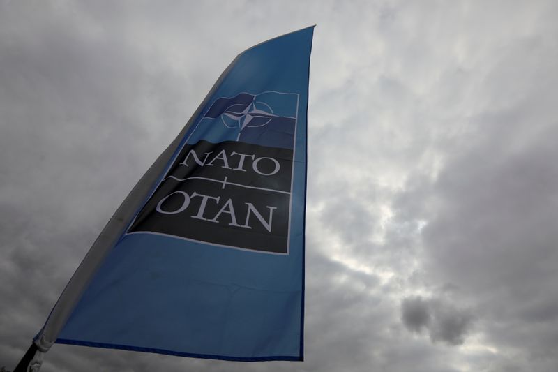 FILE PHOTO: A NATO flag is seen ahead of a