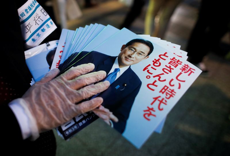 An election campaign staff member holds leaflets of Japan’s ruling