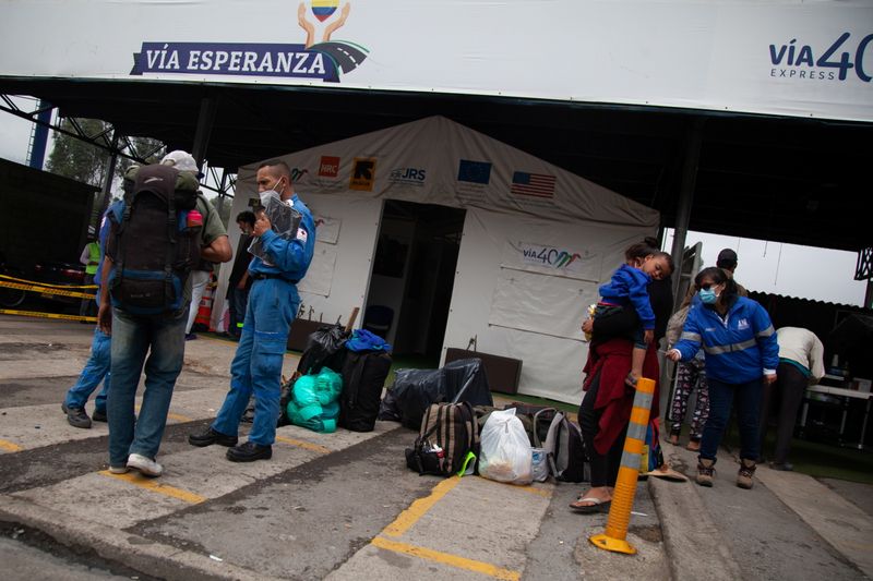Venezuelan migrants line up to register at a migrant service