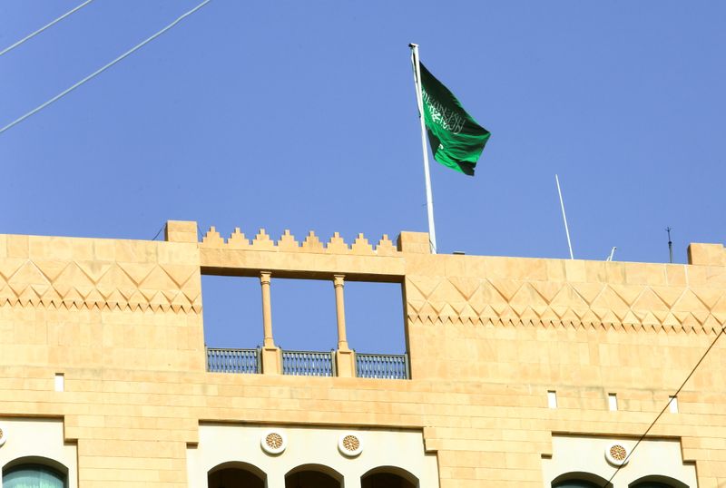 A Saudi flag flutters atop the Saudi Arabia’s embassy in