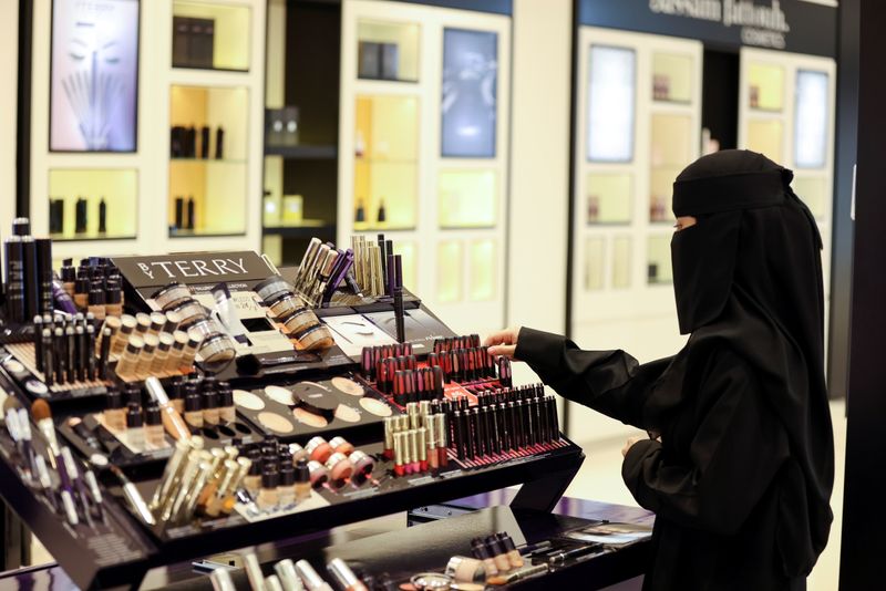 Saudi woman buys makeup from a cosmetic shop in Centria