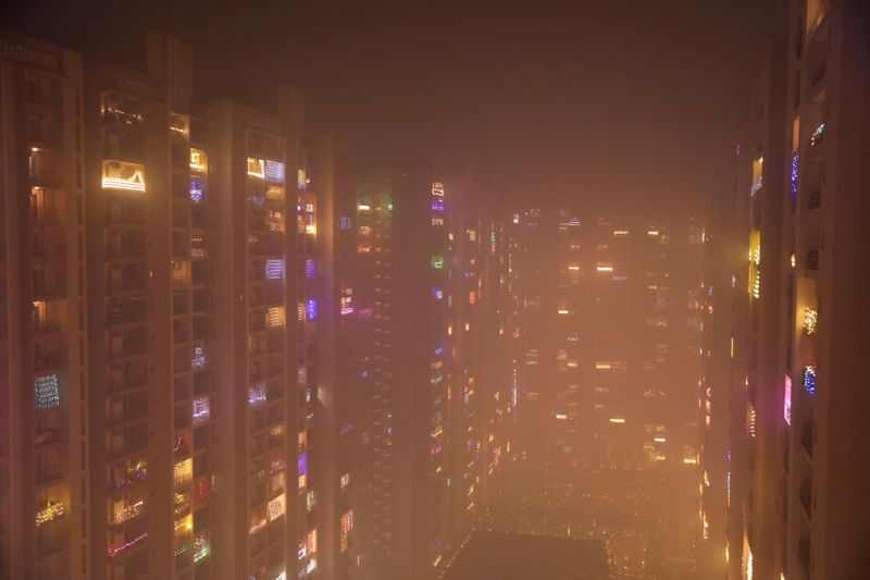 Lights decorating the balconies of a high-rise are seen shrouded