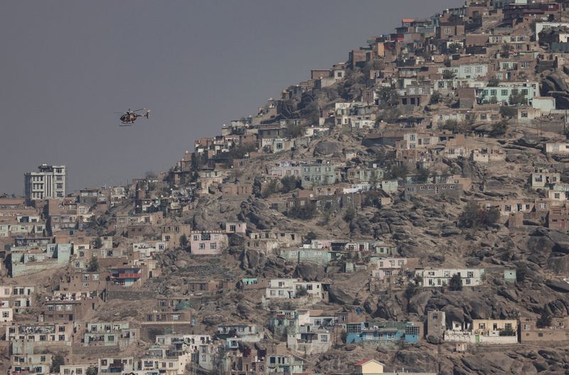 FILE PHOTO: A military helicopter is pictured flying over Kabul,