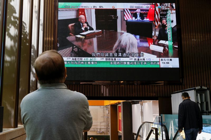A TV screen shows news of a video meeting between