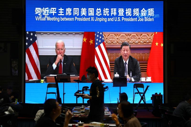 Screen shows Chinese President Xi Jinping attending a virtual meeting