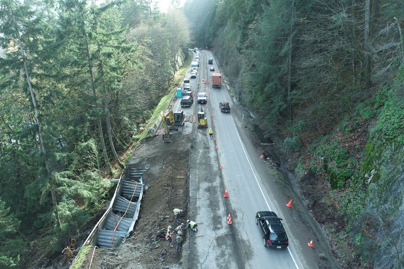 Workers inspect the Trans Canada Highway 1 after devastating rain