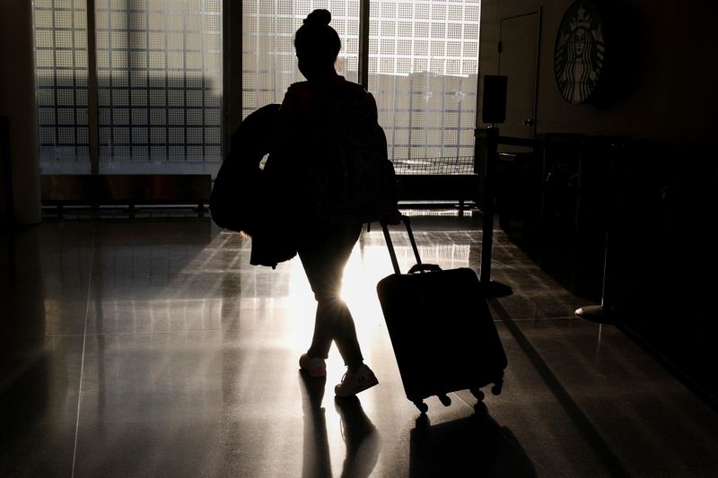 A traveler walks through O’Hare International Airport ahead of the