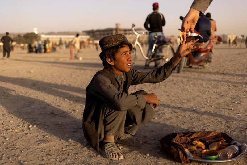 FILE PHOTO: A boy sells food in a park in