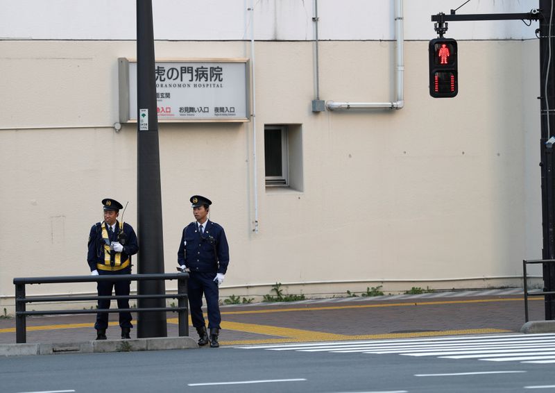 Police officers stand guard near the U.S. embassy in Tokyo,