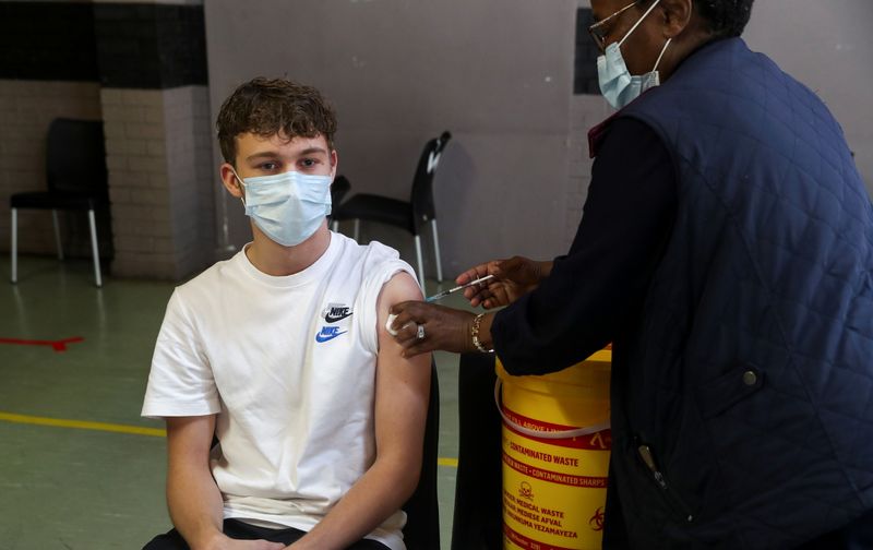 A healthcare worker administers a dose of the Pfizer coronavirus