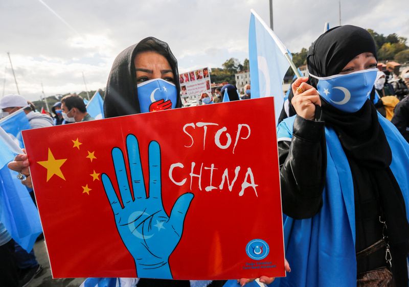 Ethnic Uighur demonstrators take part in a protest against China,
