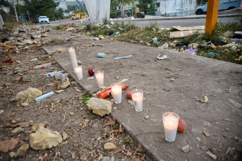 Votive candles are pictured at the site of a truck