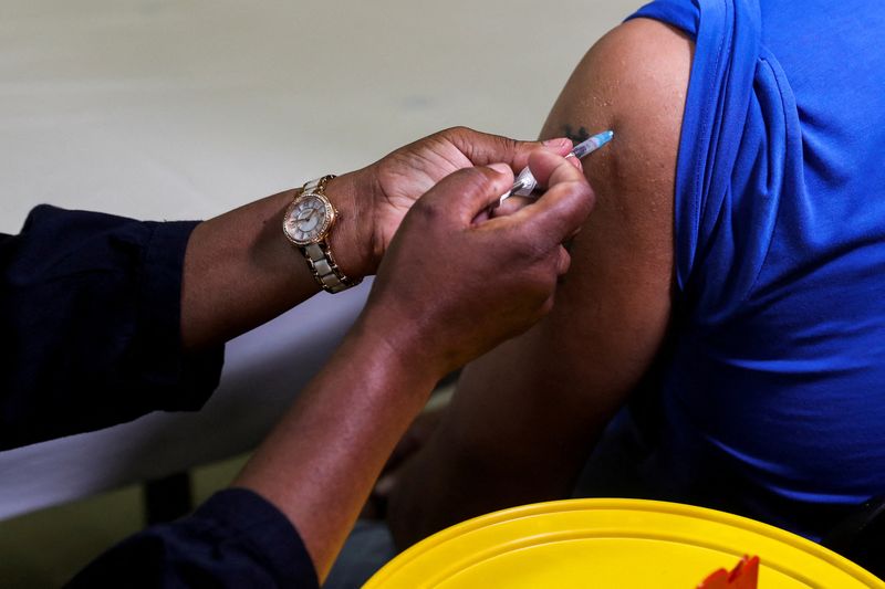 FILE PHOTO: A healthcare worker administers the Pfizer COVID-19) vaccine