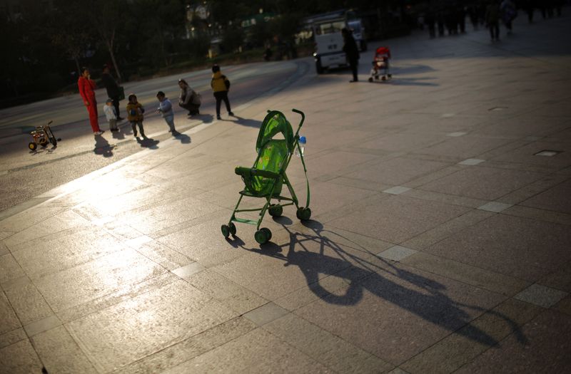 A baby stroller is seen as mothers play with their