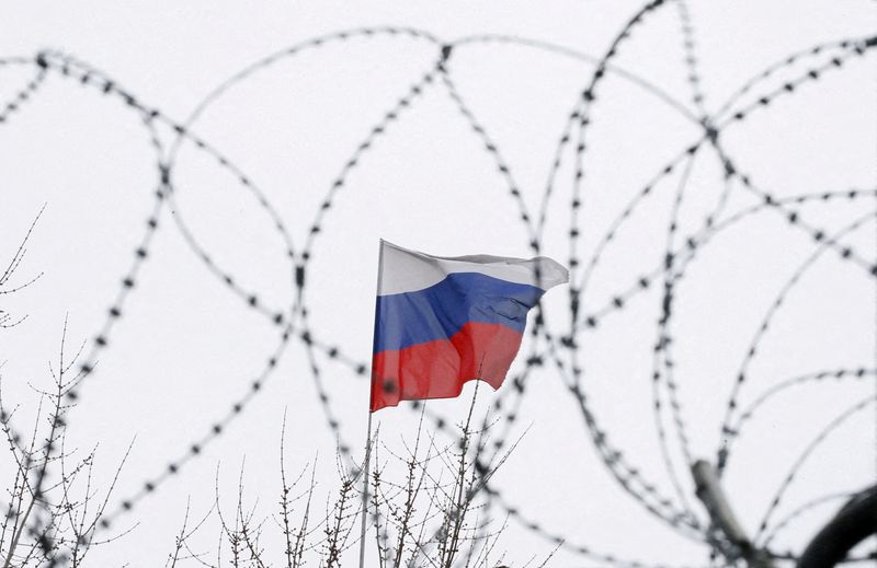 FILE PHOTO: The Russian flag is seen through barbed wire