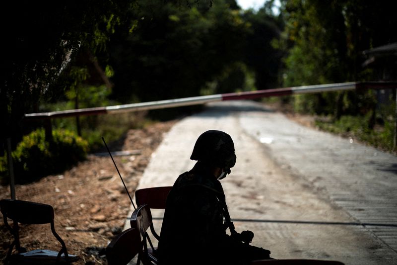 FILE PHOTO: A Thai soldier sits in front of a