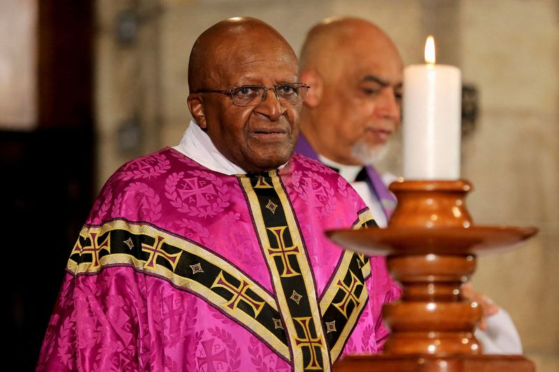 FILE PHOTO: Former Archbishop of Cape Town Tutu holds a