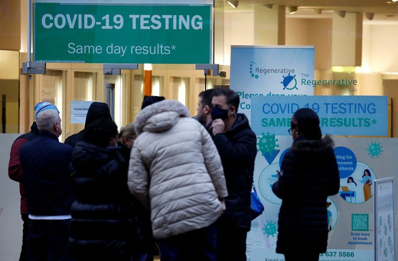 People wait outside a COVID-19 testing centre, amid the coronavirus
