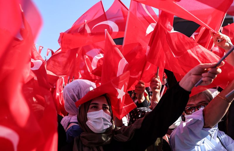 Supporters of Turkish President Tayyip Erdogan wave national flags during