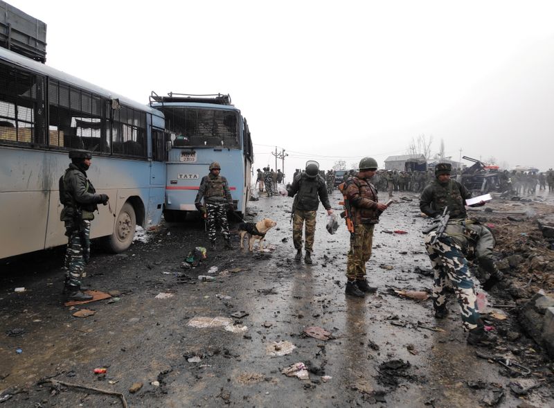 FILE PHOTO: Indian soldiers examine the debris after an explosion
