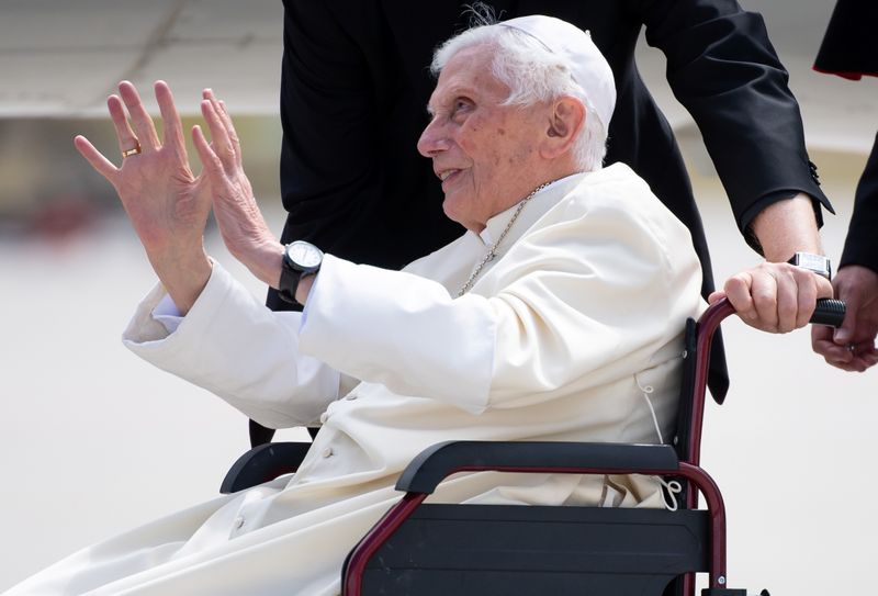 Pope Emeritus Benedict XVI gestures at the Munich Airport before