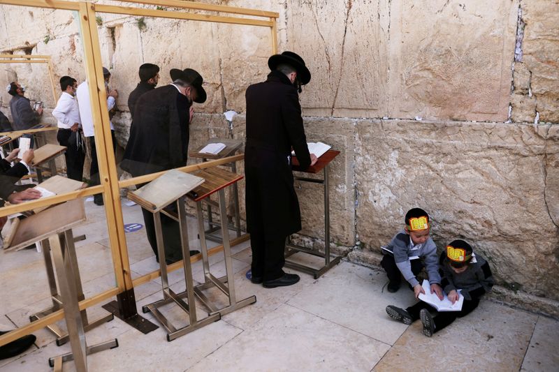 FILE PHOTO: Ultra-Orthodox Jewish boys play as men pray in