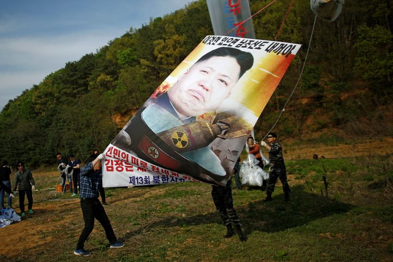FILE PHOTO: Park Sang-hak holds a banner depicting North Korean