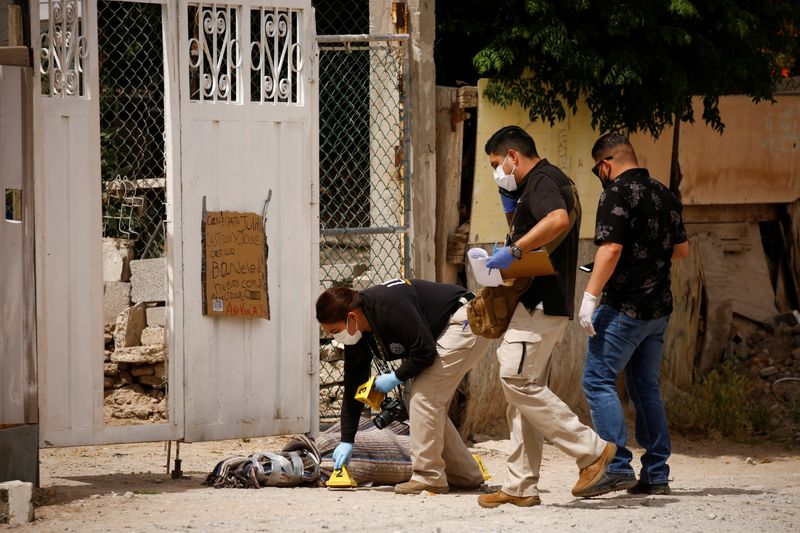 Forensic investigators work at a scene where assailants left a
