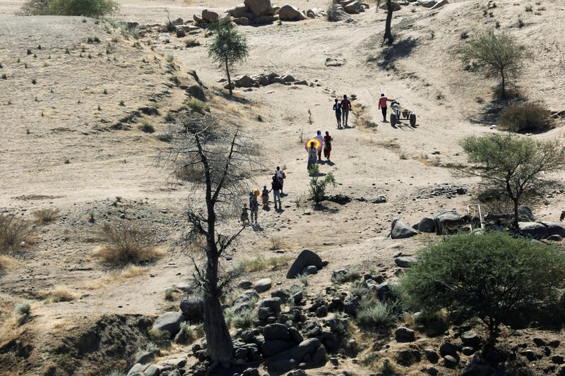 FILE PHOTO: Ethiopians fleeing from the Tigray region walk towards