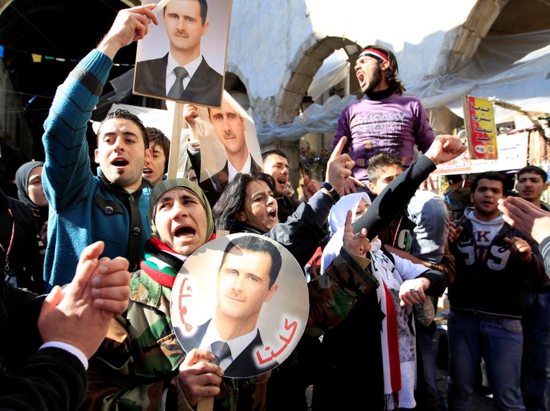 FILE PHOTO: Supporters of Syria’s President Bashar al-Assad attend a