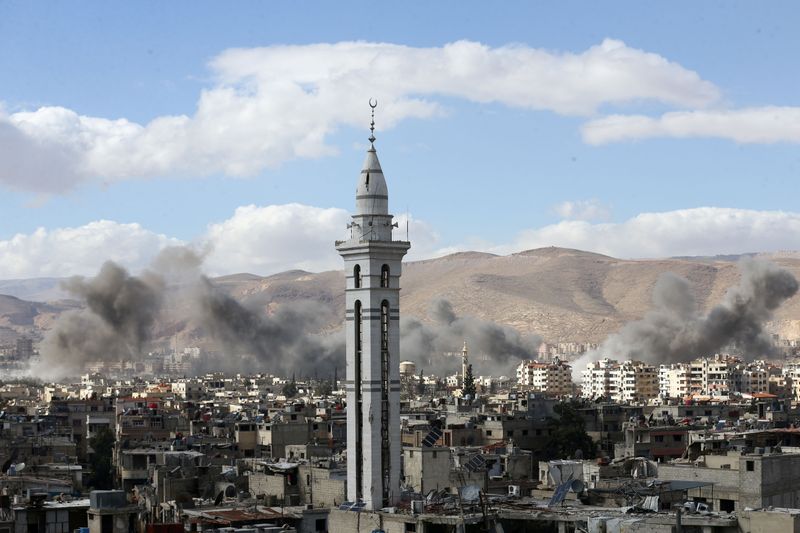 FILE PHOTO: Smoke rises from the besieged Eastern Ghouta in