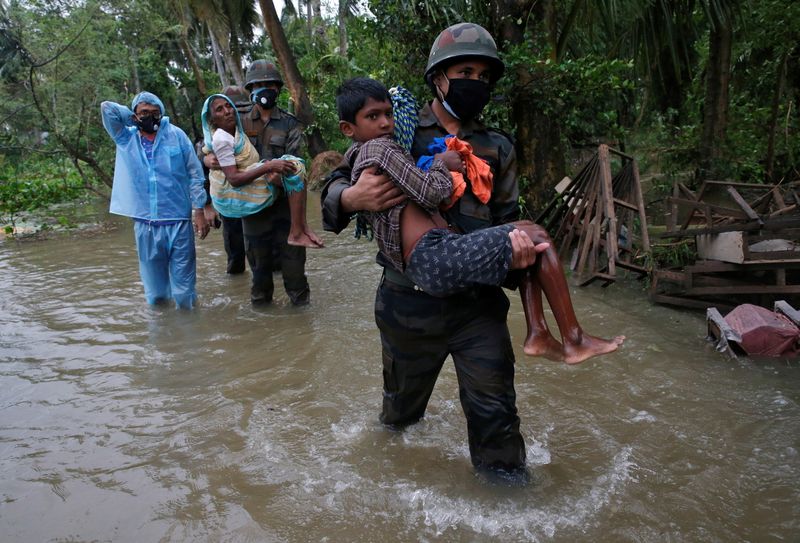Army soldiers evacuate people from a flooded area to safer