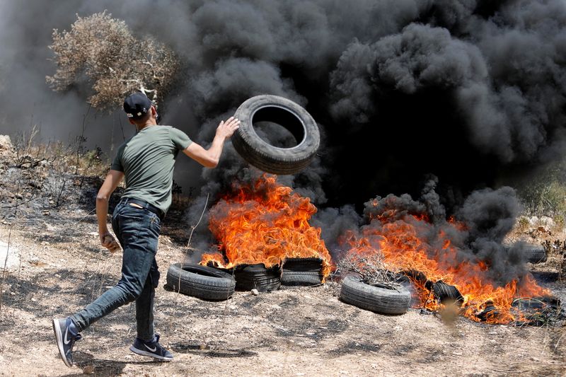 Palestinians protest against Israeli settlements, in West Bank