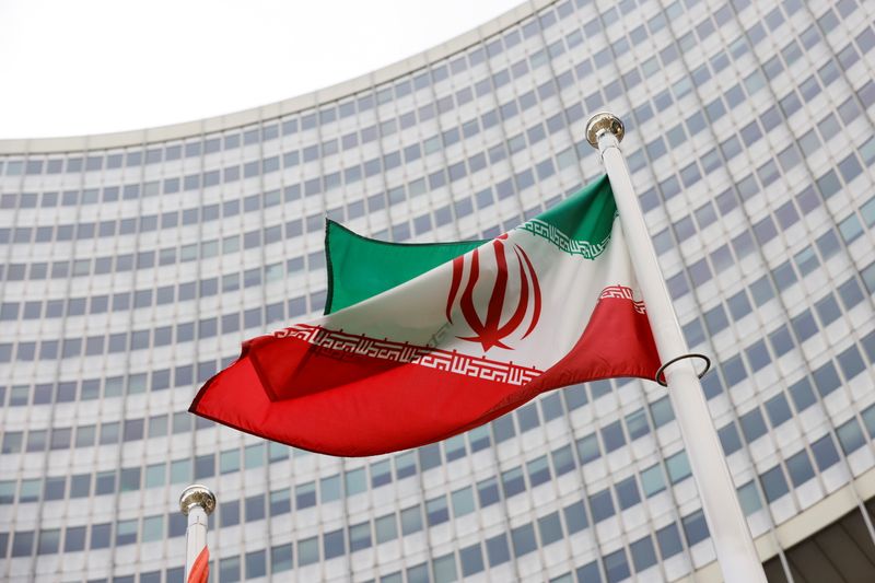 The Iranian flag waves in front of the International Atomic