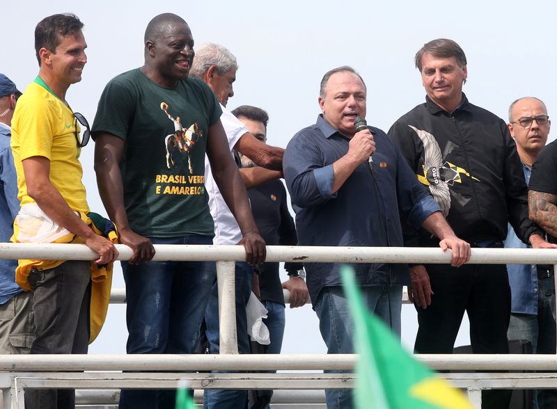 Brazil’s President Bolsonaro and former Health Minister Pazuello attend a