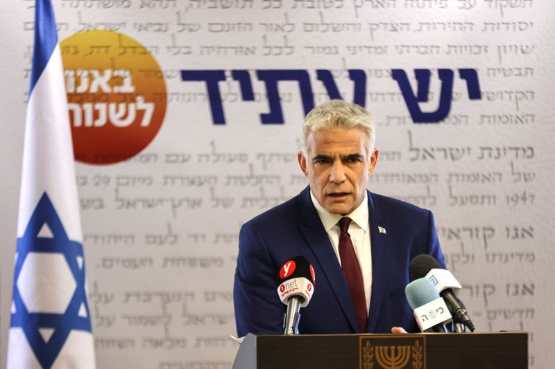 Yesh Atid party leader, Yair Lapid, speaks to the media
