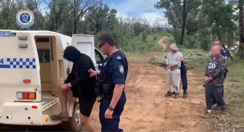 Persons are detained by Australian Federal Police after its Operation