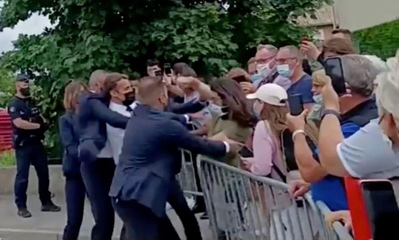 French President Emmanuel Macron is slapped in the face by