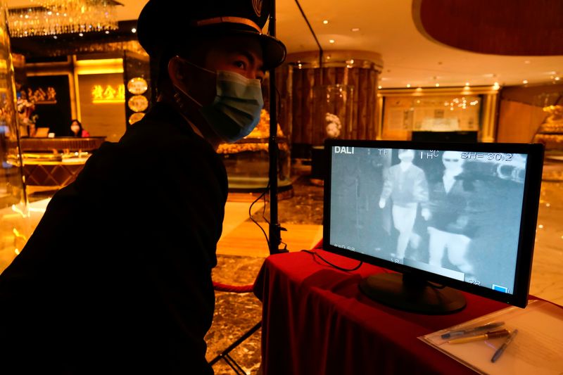 FILE PHOTO: A security guard monitors thermal scanners that detect