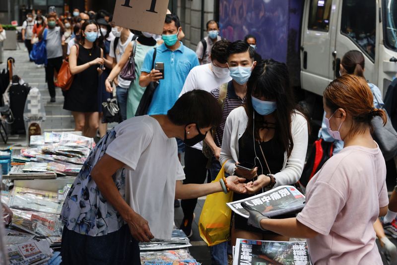 People queue to buy copies of the final edition of
