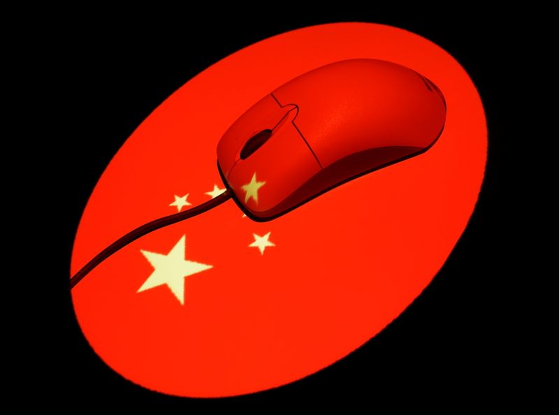 FILE PHOTO: Photo illustration of a computer mouse illuminated by