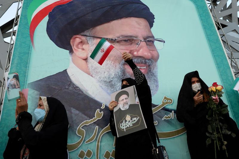 FILE PHOTO: A supporter of Ebrahim Raisi displays his portrait