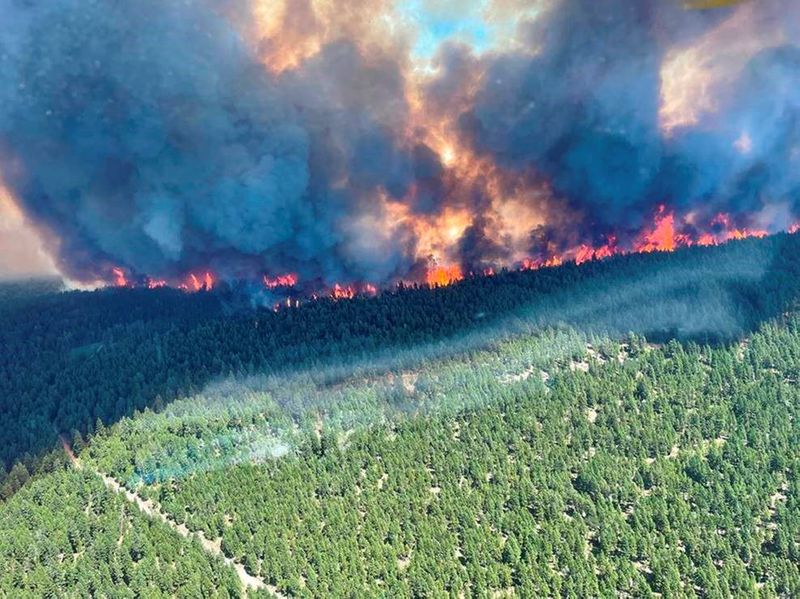 Smoke and flames are seen during the Sparks Lake wildfire