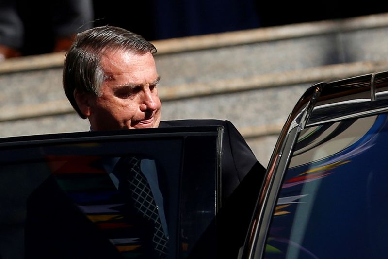 Brazil’s President Jair Bolsonaro walks from Catholic church in Brasilia