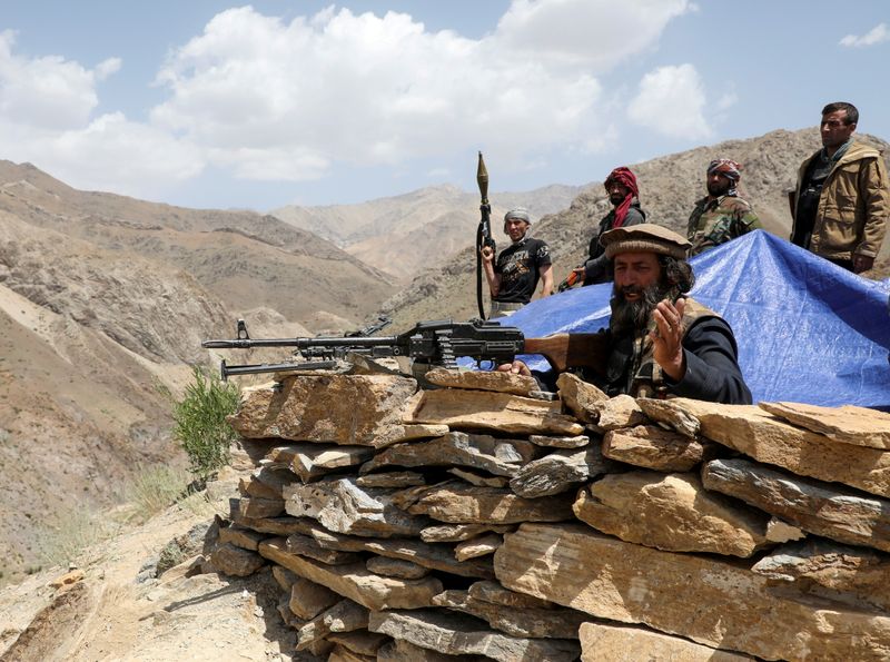 FILE PHOTO: Armed men who are against Taliban uprising stand