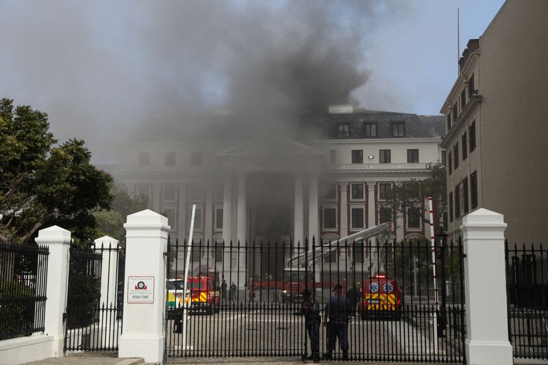 Firefighters work after a fire broke out in the Parliament